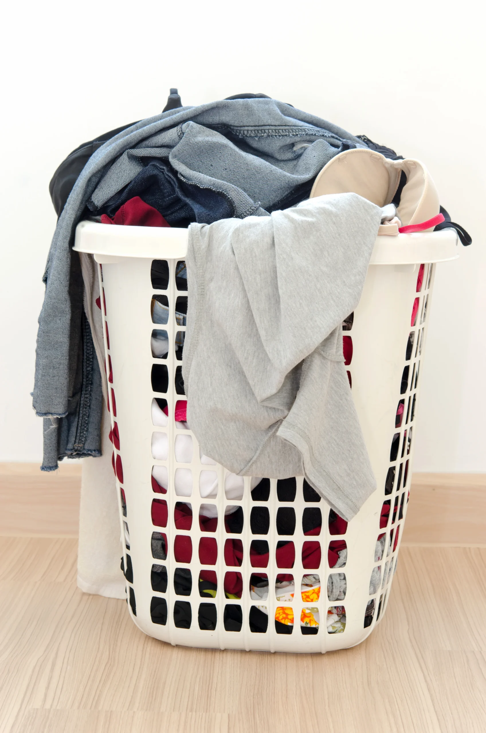 51526820_l (1) Clothes basket on floor in room.